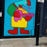 Guitar player by Thierry Noir on a wall in London