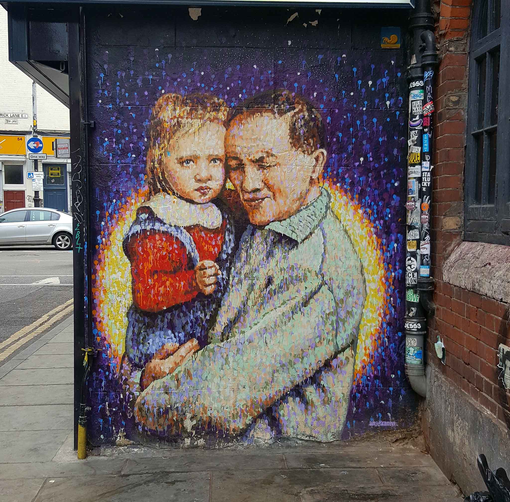 A man holding a small girl in his arms. Street Art by Jimmy C