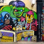 Mural of the 4 avengers reading a comic in London