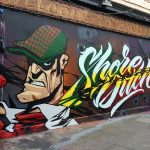 Streetart in Shoreditch, London, showing a gangster with a smoking gun